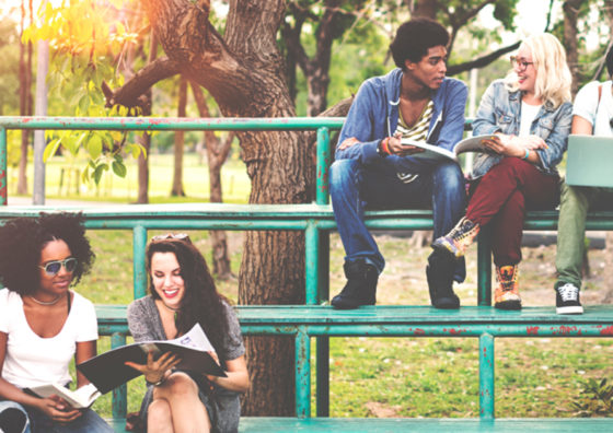 Teenagers sitting on bleachers