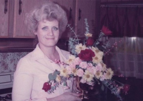 woman with bouquet in kitchen