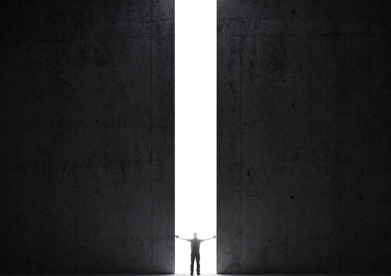 person standing between giant doors