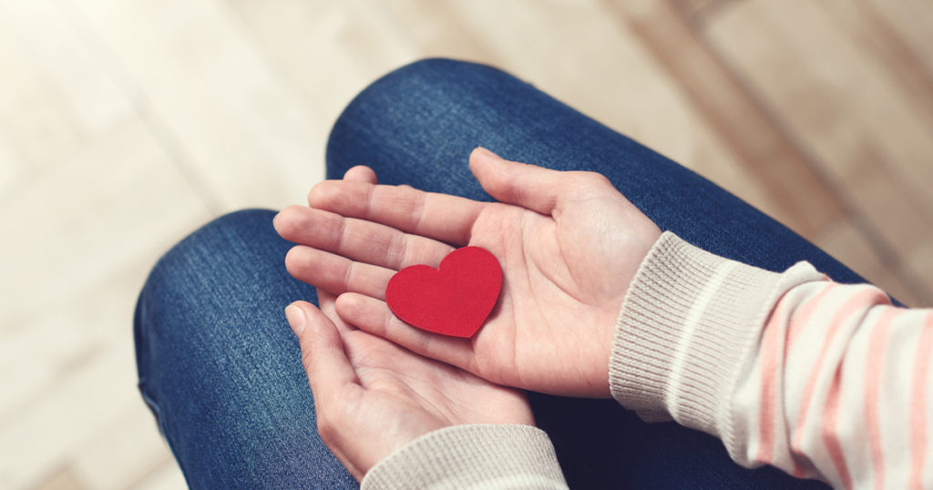 cut-out heart in hand