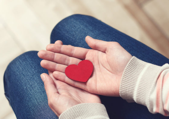 cut-out heart in hand