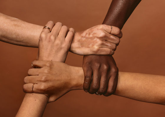 interlinked arms with hands on wrists