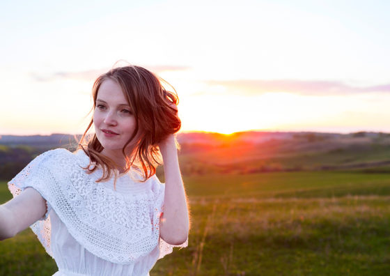 woman taking selfie in field