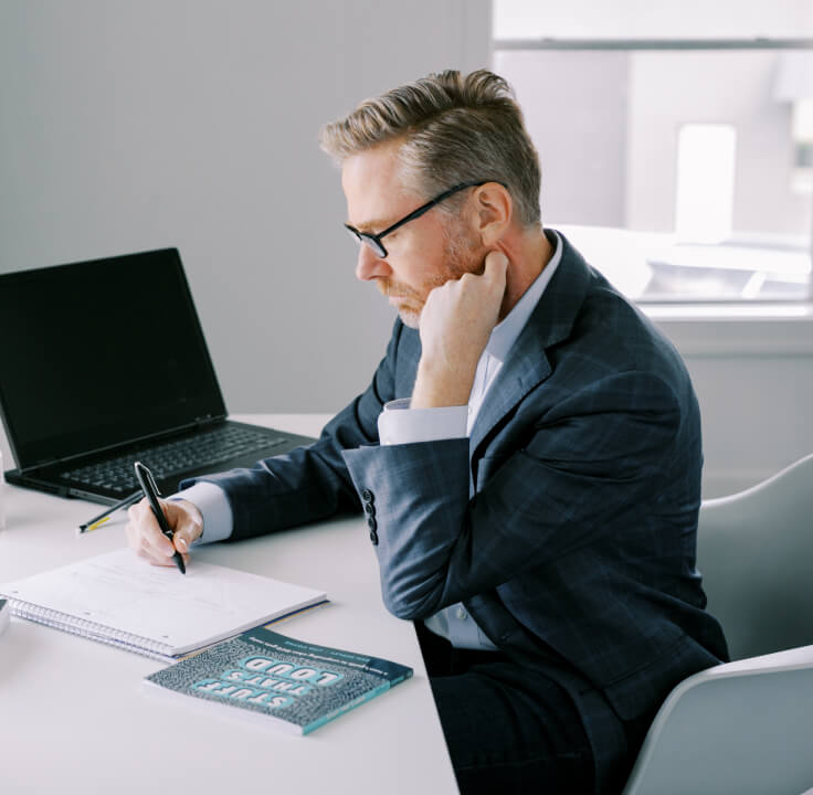 Matt Boone writing at a desk